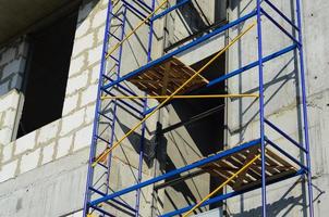 Blue and yellow construction scaffolding of a Russian building under renovation. photo