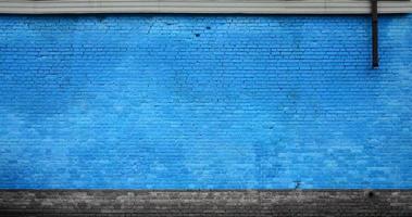 la textura de la pared de ladrillo de muchas filas de ladrillos pintados de color azul foto