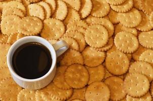 Small coffee cup and salted cracker photo