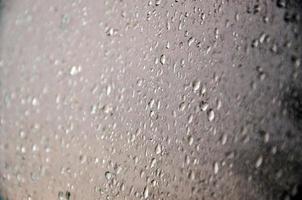 Background image of rain drops on a glass window. Macro photo with shallow depth of field