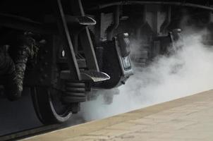 Black wheels of an old freight railcar photo