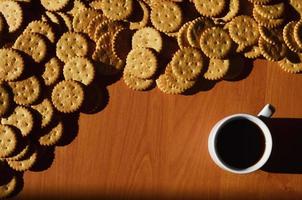 Small coffee cup and salted cracker photo