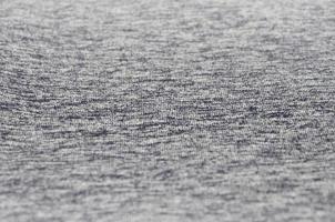 Real heather knitted fabric made of synthetic fibres textured background. Colored fabric texture. Background with delicate striped pattern photo