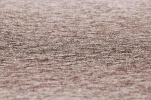 Real heather knitted fabric made of synthetic fibres textured background. Colored fabric texture. Background with delicate striped pattern photo