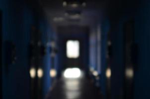 The blurred image of gloomy corridor of a neglected public building. Defocused picture of a public space in a poor residential high-rise building photo