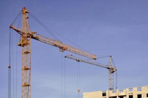 Building under construction with crane photo