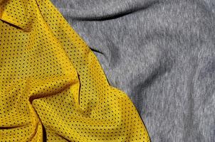 Top view of cloth textile surface. Close-up rumpled heater and knitted fabric texture with a thin striped pattern. Sport clothing fabric texture. Colored basketball shirt and heater hoodie photo