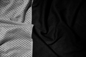 Sport clothing fabric texture background. Top view of grey polyester nylon cloth textile surface. Dark photo