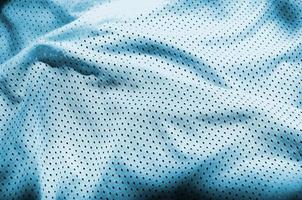 Blue sport clothing fabric texture background. Top view of light blue cloth textile surface. Bright basketball shirt. Text Space photo