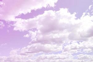 A blue sky with lots of white clouds of different sizes photo