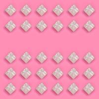 A lot of pink gift boxes lies on texture background of fashion pastel pink color paper in minimal concept. Abstract trendy pattern photo