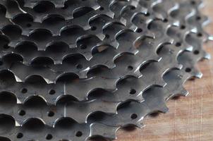 Rear cassette sprocket from a mountain bike lying on a wooden table in a bike shop photo