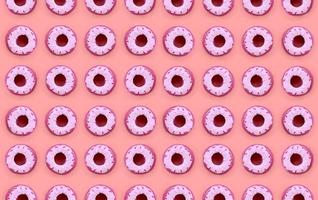 Many small plastic donuts lies on a pastel colorful background. Flat lay minimal pattern. Top view photo