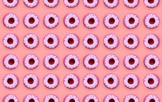 Many small plastic donuts lies on a pastel colorful background. Flat lay minimal pattern. Top view photo