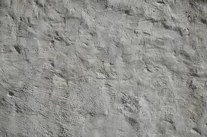 Close up shot of grunge brown clay wall on a old house. The mixture of some other object such as wood and stone photo