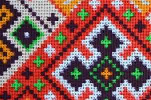 Traditional Ukrainian folk art knitted embroidery pattern on textile fabric photo