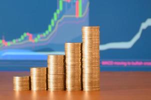 Golden coin stacks arranged as a graph. Increasing columns of coins photo