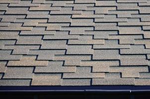 Modern roofing and decoration of chimneys. Flexible bitumen or slate shingles photo