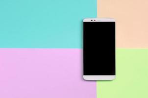 Modern smartphone with black screen on texture background of fashion pastel pink, blue, coral and lime colors photo