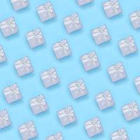 A lot of blue gift boxes lies on texture background of fashion pastel blue color paper in minimal concept photo