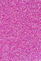 Pink decorative sequins. Background image with shiny bokeh lights from small elements photo