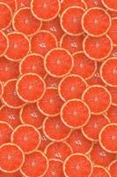 Pattern of red grapefruit citrus slices. Citrus flat lay photo