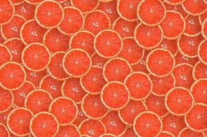 Pattern of red grapefruit citrus slices. Citrus flat lay photo