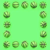 Frame of a many small green balls for basketball sport game lies on texture background photo