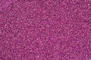 Pink decorative sequins. Background image with shiny bokeh lights from small elements photo