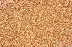 Orange decorative sequins. Background image with shiny bokeh lights from small elements photo