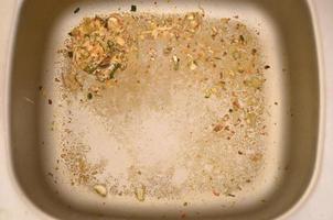 Close up on dirty clogging kitchen sink drain with food particles photo