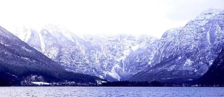 Panorama of Hallstatt lake outdoor with snow mountain background blue tone in Austria in Austrian alps photo