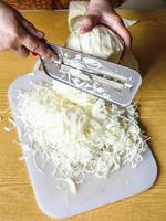 woman chopping cabbage on cutting board photo