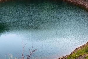 green water of Kerid lake in volcanic crater photo