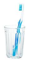 blue toothbrush in glass isolated on white photo