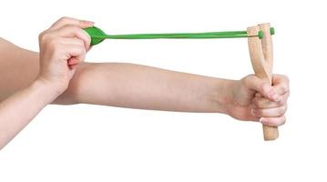 hands pull rubber band of slingshot isolated photo