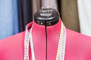 mannequin with measure tapes and clothes photo