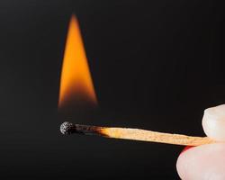 flame of lighted wooden match photo