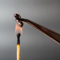 match flame ignites cotton threads photo