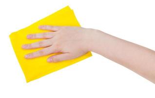 hand with yellow cleaning rag isolated on white photo