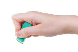 hand with green rubber eraser close up isolated