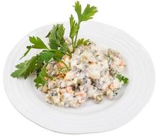 above view of russian salad decorated with parsley photo