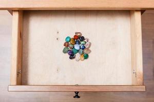 pile of gem stones in open drawer photo