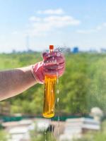 washer sprays liquid from spray bottle to glass photo