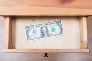 one dollar bill in open drawer photo