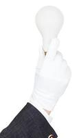 male hand in suit and glove holds bulb light photo