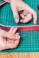 craftsman sews new leather belt photo