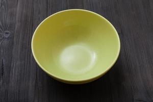 green bowl on dark brown board photo