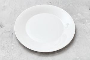 white plate on gray concrete surface photo