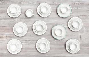 top view of cups and saucers on gray brown table photo